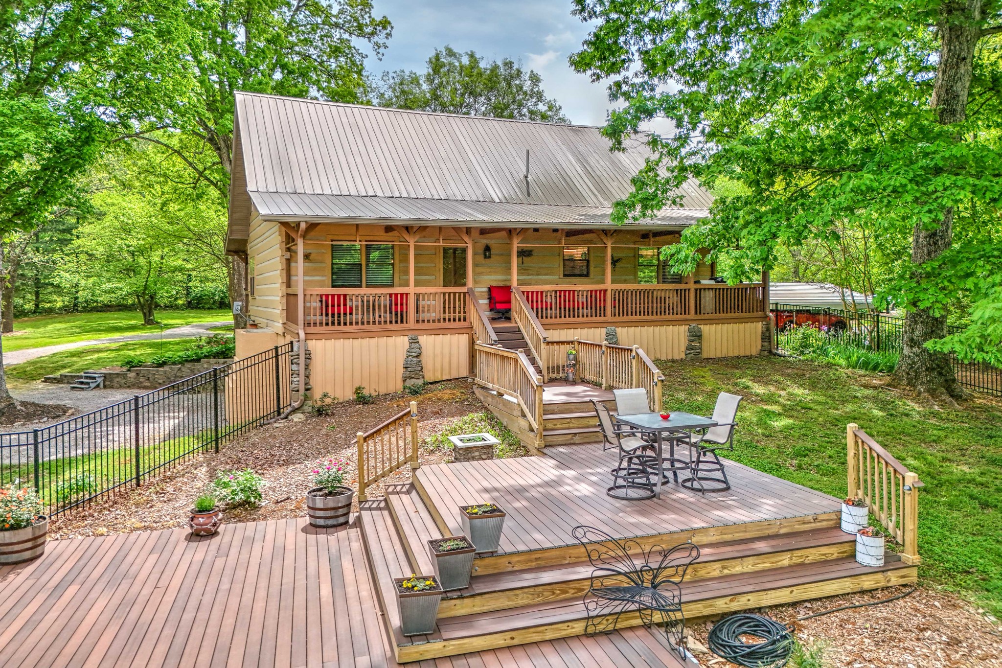 1708 Sugar Ridge Road Spring Hill, TN 37174 - Photo 48 of 70 a view of a patio with table and chairs potted plants with wooden floor and fence