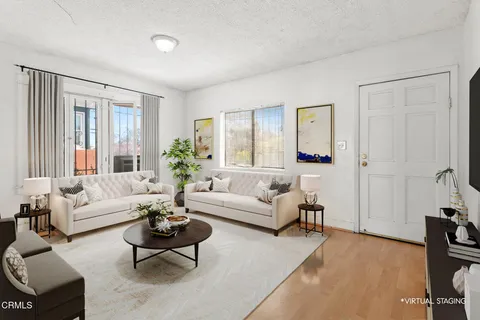 a living room with furniture and a large window