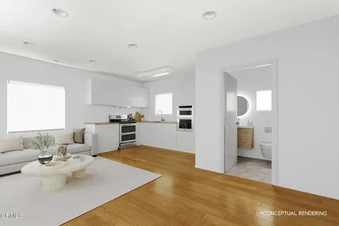 a view of kitchen with white cabinets and refrigerator