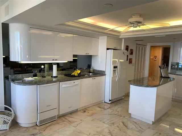 a kitchen with granite countertop a sink and cabinets