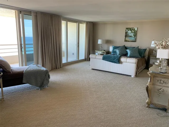 a living room with furniture a rug and white walls