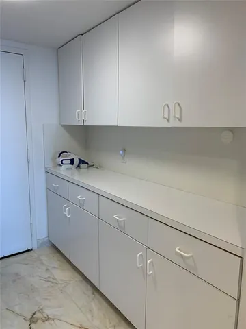 a front view of a building with palm trees