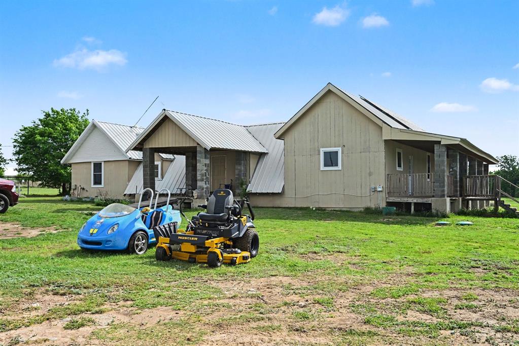 6694 Hutcheson Hill Road Springtown, TX 76082 - Photo 2 of 37 a front view of house with yard and outdoor seating