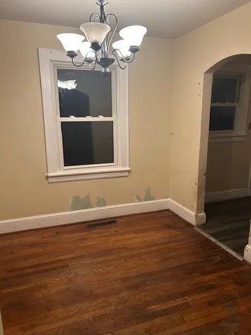 a view of a room with wooden floor and chandelier