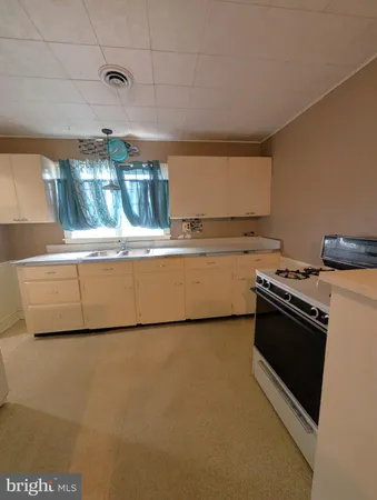 a stove top oven sitting inside of a kitchen