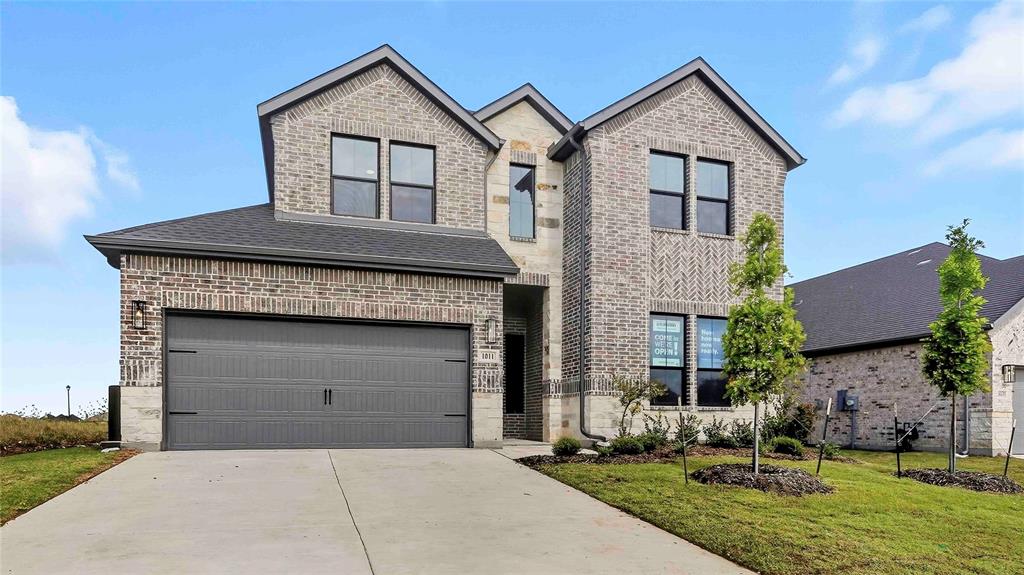 1011 Pitchfork Road Royse City, TX 75189 - Photo 2 of 19 a front view of a house with a yard and garage