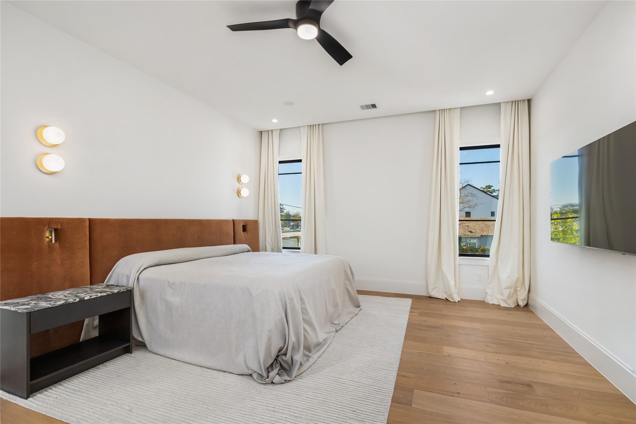 419 West 30th Street Houston, TX 77018 - Photo 22 of 45 a bedroom with a large bed and a chandelier