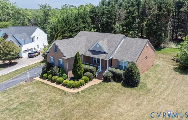 an aerial view of a house with a yard and potted plants