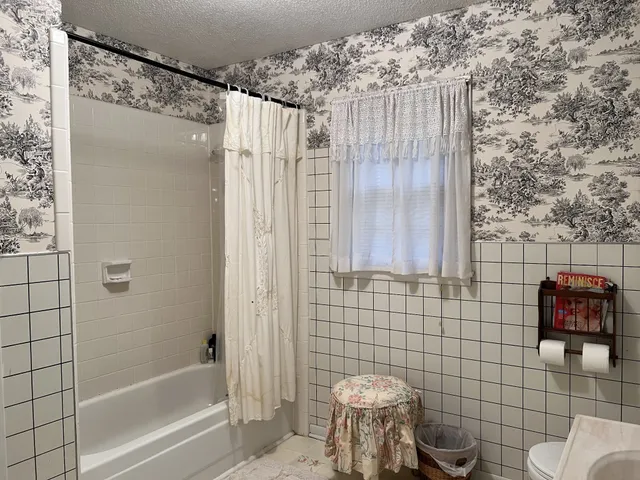 a bathroom with a toilet and shower