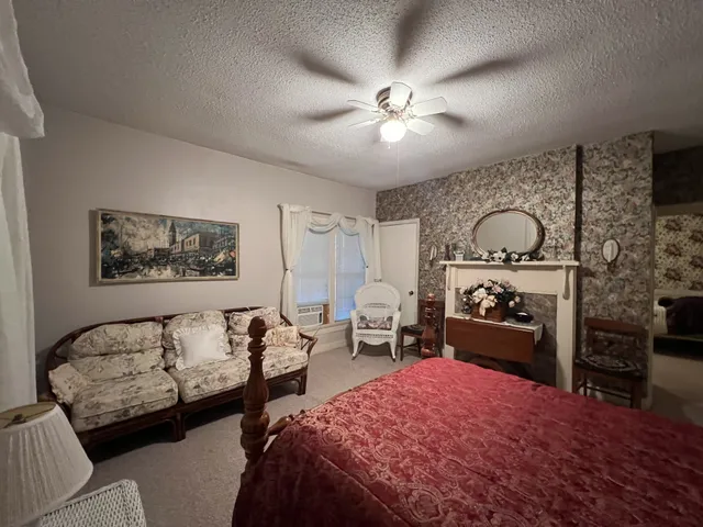 a bedroom with furniture and a fireplace
