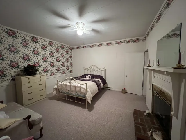 a bedroom with a bed and a fireplace