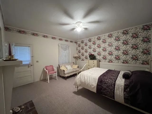 a bedroom with bed and window
