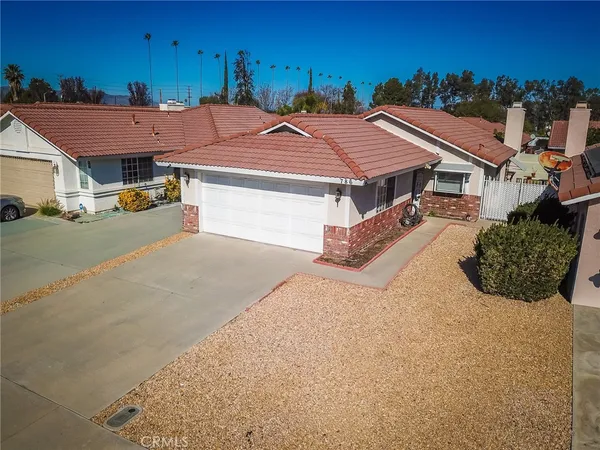 an aerial view of a house with yard