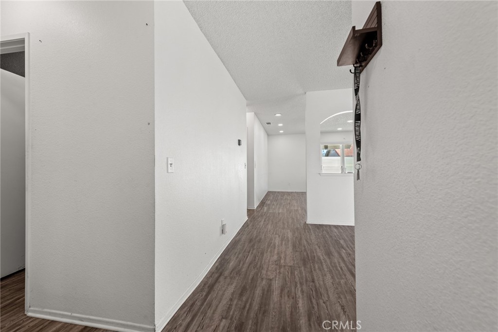 786 Zephyr Circle Hemet, CA 92543 - Photo 11 of 26 a view of a hallway with wooden floor