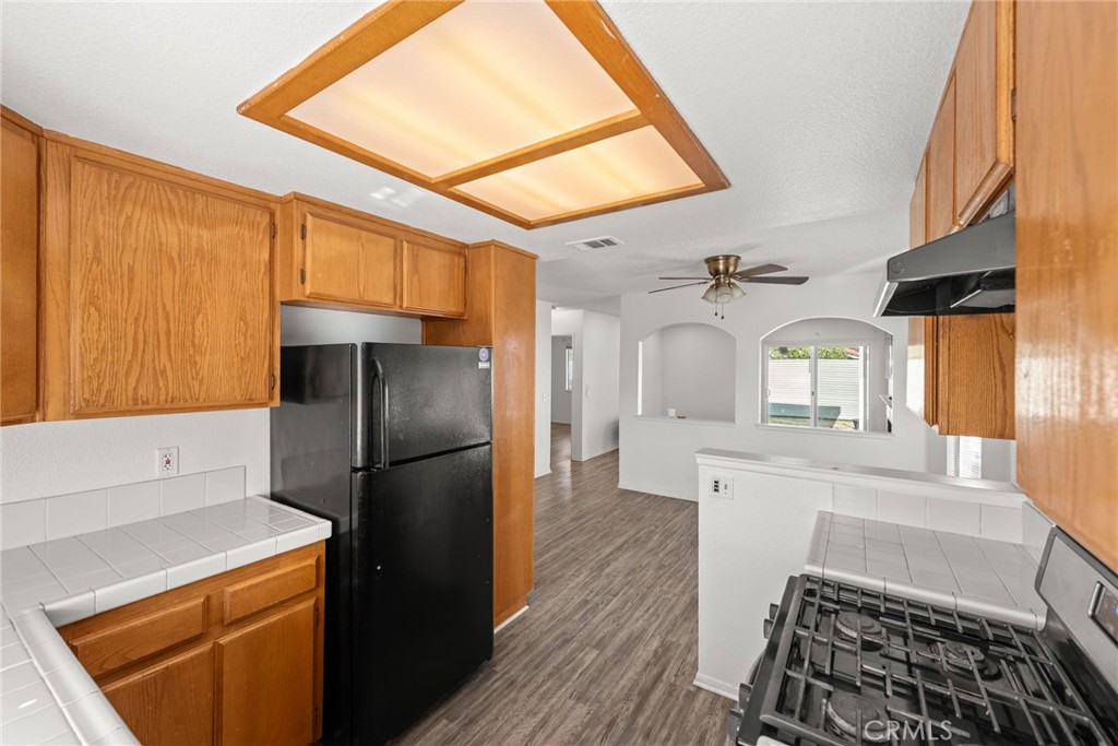 786 Zephyr Circle Hemet, CA 92543 - Photo 13 of 26 a kitchen with a refrigerator and a stove