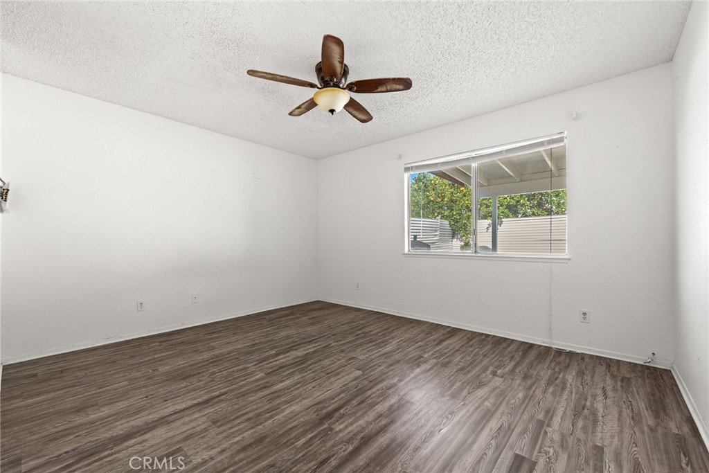 786 Zephyr Circle Hemet, CA 92543 - Photo 14 of 26 a view of empty room with wooden floor and fan