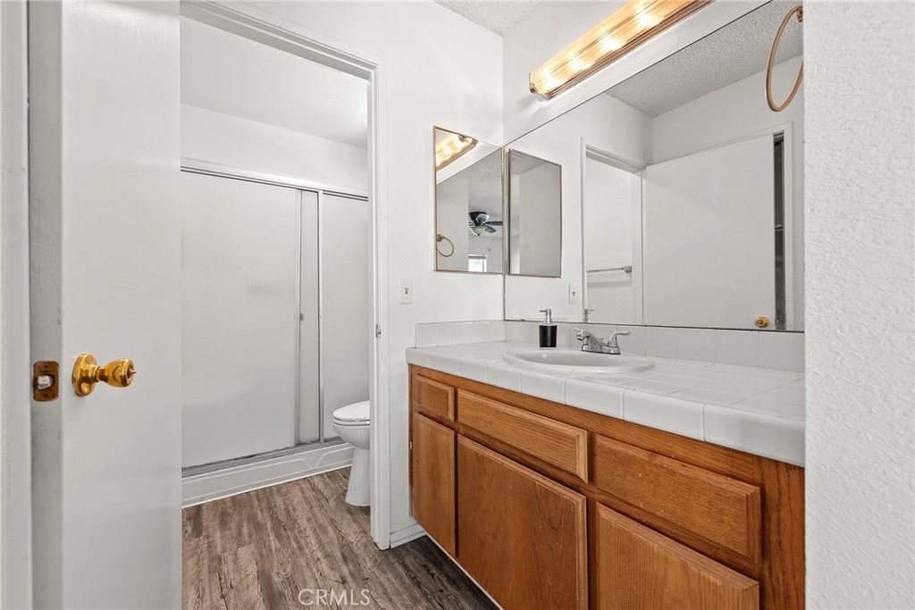 786 Zephyr Circle Hemet, CA 92543 - Photo 15 of 26 a bathroom with a sink a toilet and shower