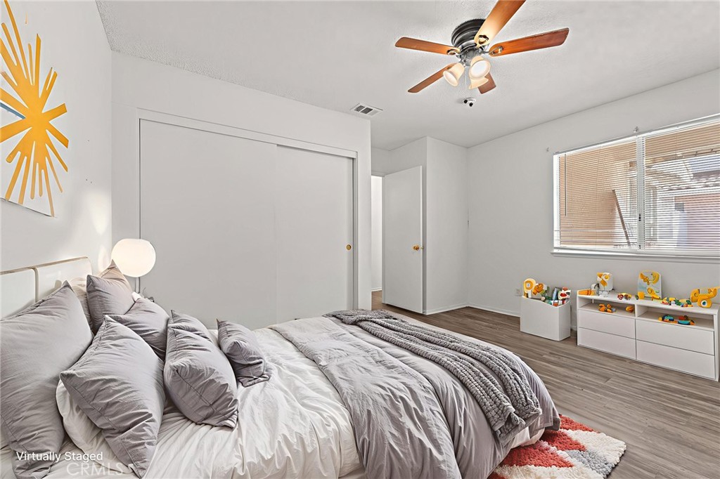 786 Zephyr Circle Hemet, CA 92543 - Photo 21 of 26 a bedroom with bed and a chandelier