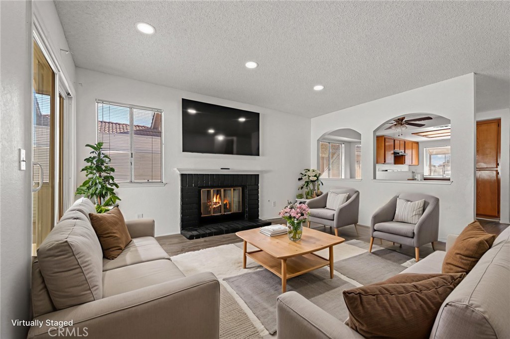 786 Zephyr Circle Hemet, CA 92543 - Photo 23 of 26 a living room with furniture a flat screen tv and a fireplace