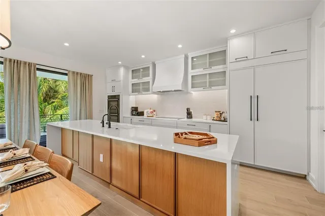 a view of a chairs and table in patio with wooden floor