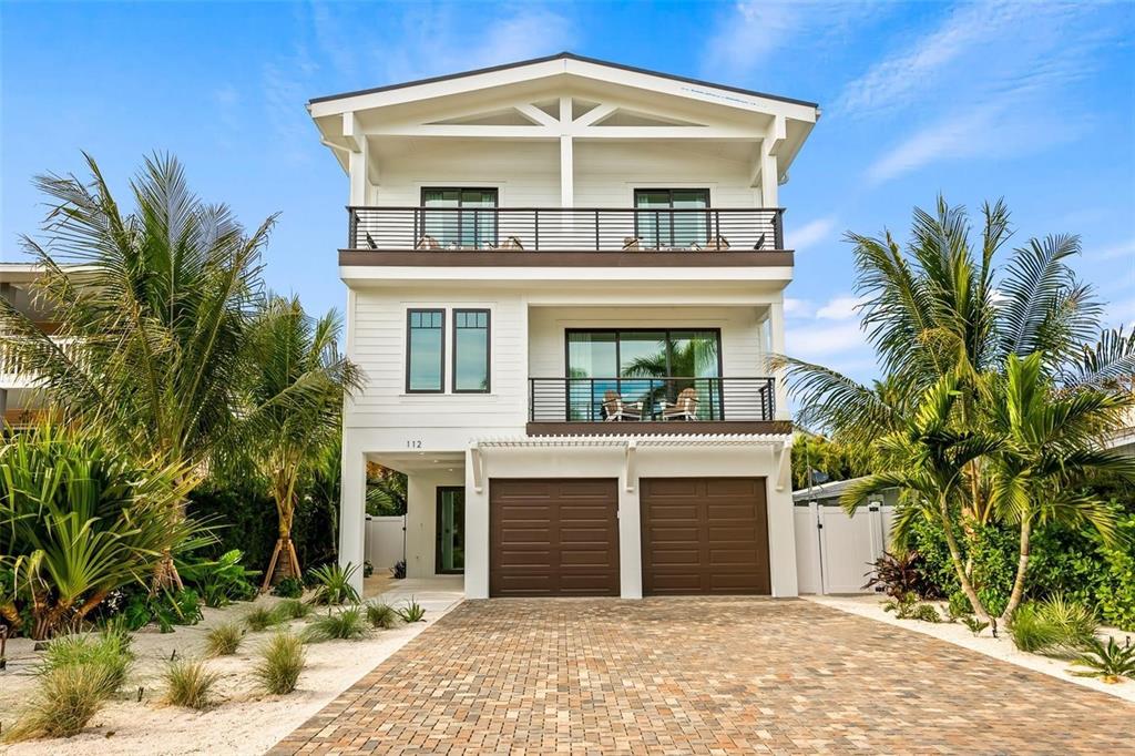 112 Maple Avenue Anna Maria, FL 34216 - Photo 2 of 100 a front view of a house with a garden