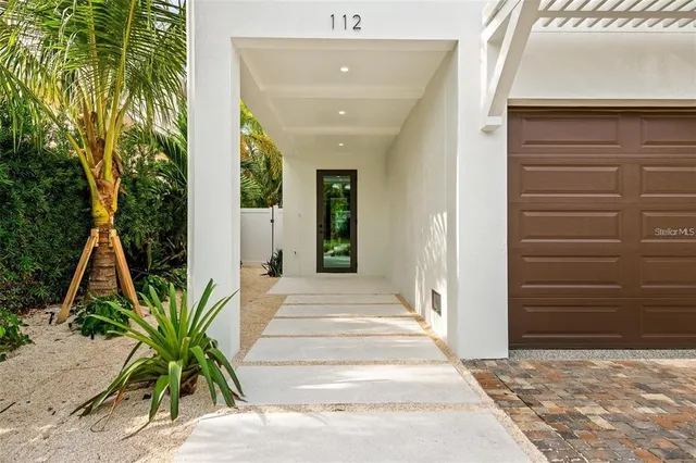 a living room with furniture kitchen view and a chandelier