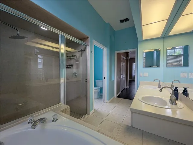 a large kitchen with stainless steel appliances granite countertop a sink and a refrigerator