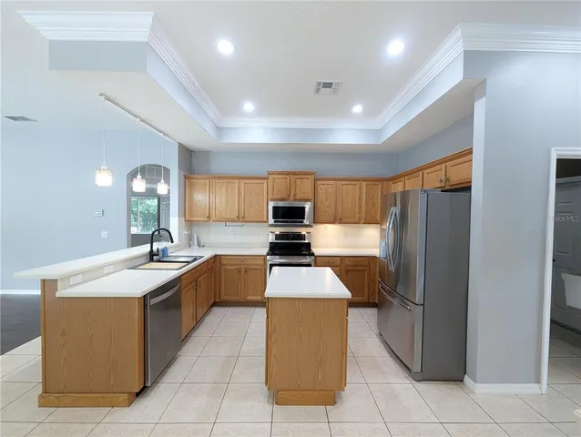 a view of kitchen with granite countertop fireplace and wooden floor