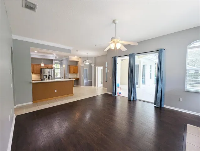 a large kitchen with kitchen island a large counter top stainless steel appliances and cabinets