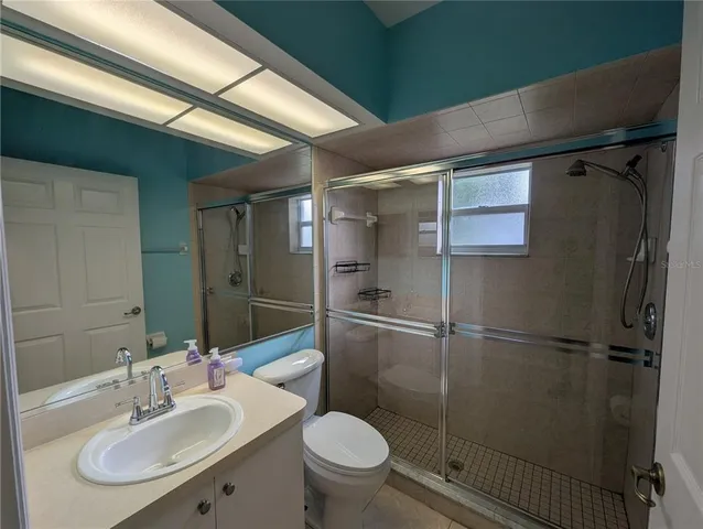 a view of a room that has wooden floor and window in it