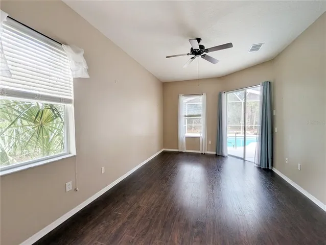 a view of an empty room and wooden floor