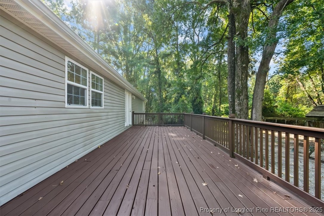 11891 Aberdeen Road Aberdeen, NC 28315 - Photo 31 of 35 a view of deck with wooden floor and fence