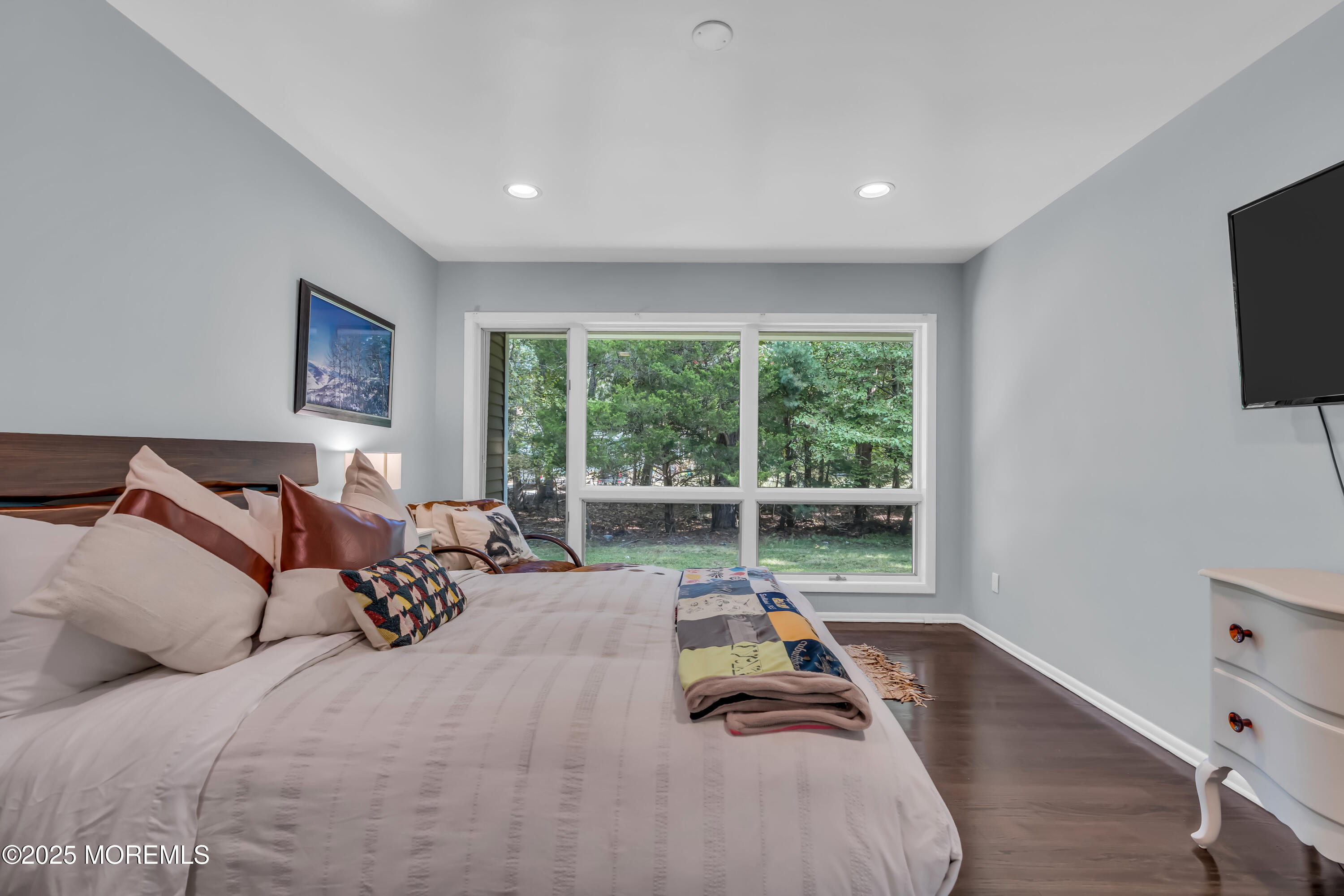 1264 Deal Road Asbury Park, NJ 07712 - Photo 30 of 70 a bed room with a bed and a flat tv screen on dresser