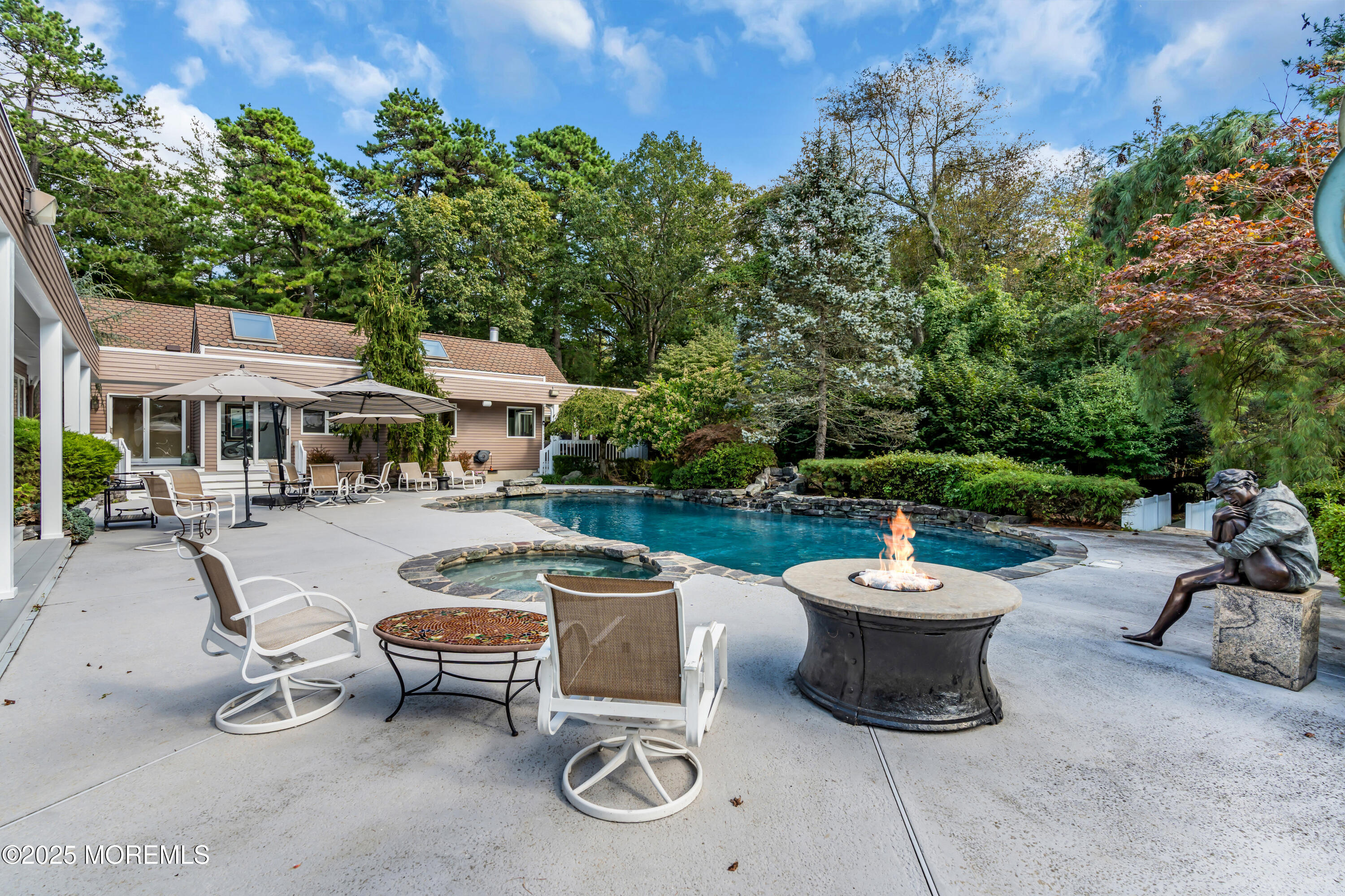 1264 Deal Road Asbury Park, NJ 07712 - Photo 67 of 70 a view of a patio with table and chairs potted plants and a palm tree