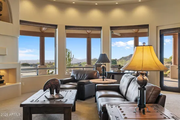 a kitchen with stainless steel appliances granite countertop a sink a stove and a refrigerator with wooden cabinets