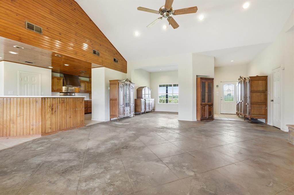 12190 Bell Road Pilot Point, TX 76258 - Photo 11 of 39 Spacious living area featuring concrete flooring and a vaulted wood-paneled ceiling with recessed lighting