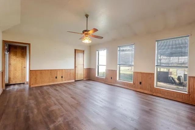 a bathroom with a granite countertop sink a toilet and a mirror