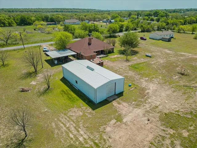 an aerial view of a house with a yard
