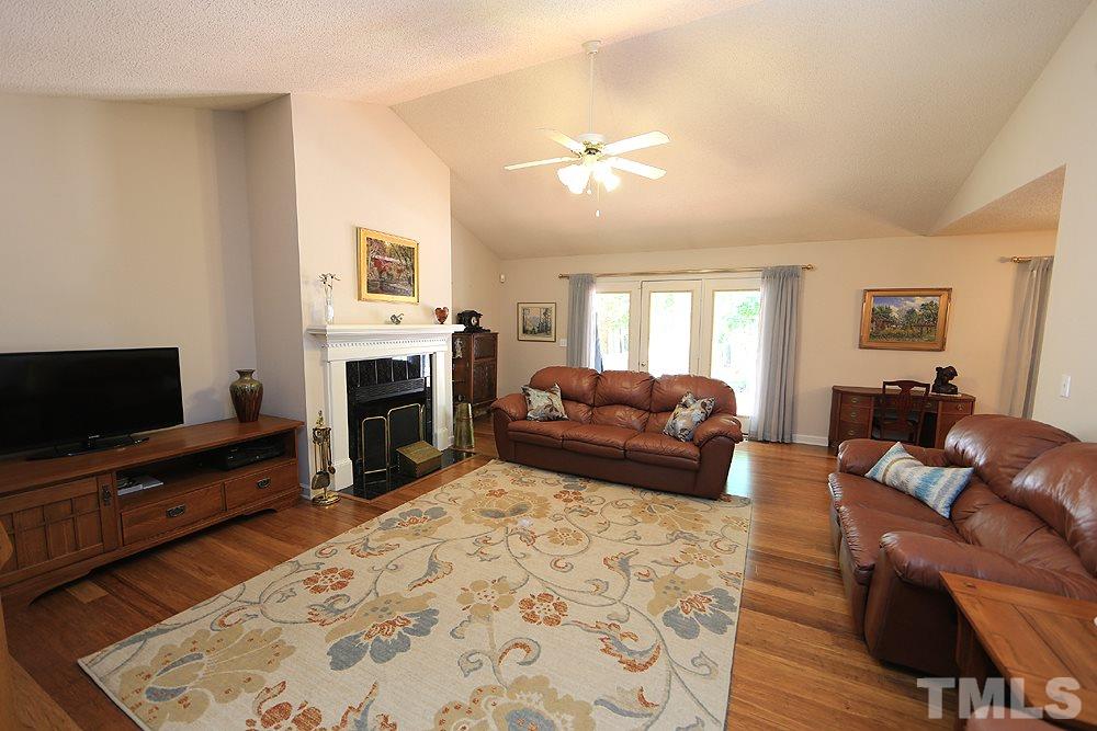 1295 Pilot-Riley Road Zebulon, NC 27597 - Photo 2 of 18 a living room with furniture a flat screen tv and a fireplace