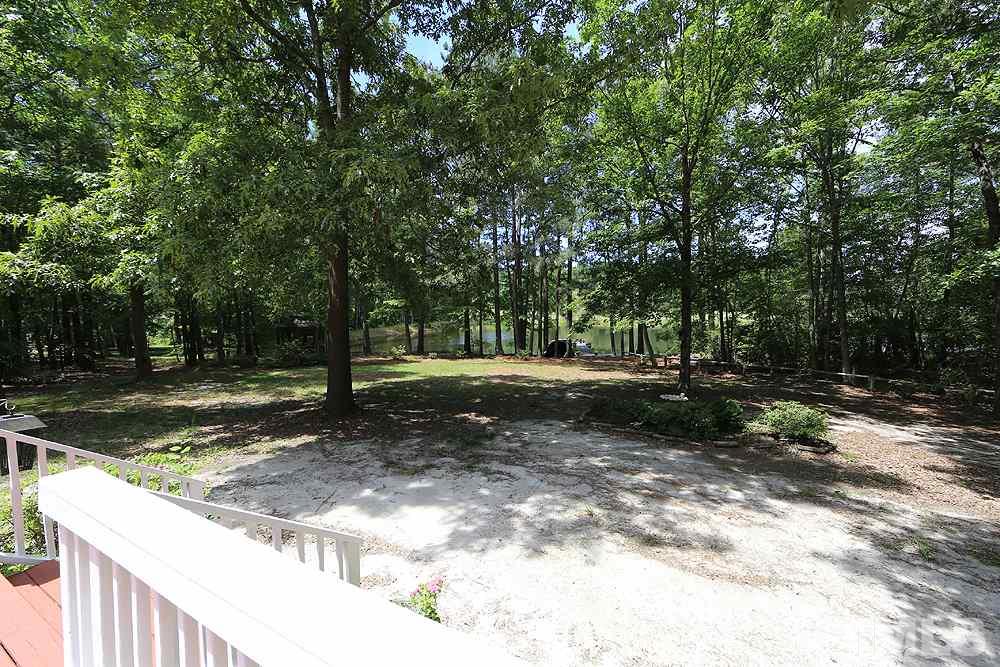 1295 Pilot-Riley Road Zebulon, NC 27597 - Photo 11 of 18 a view of a tree in the middle of a yard