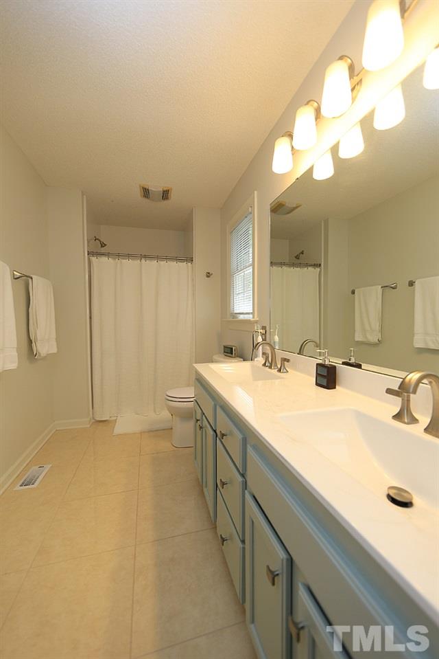 1295 Pilot-Riley Road Zebulon, NC 27597 - Photo 7 of 18 a bathroom with a double vanity sink mirror and double