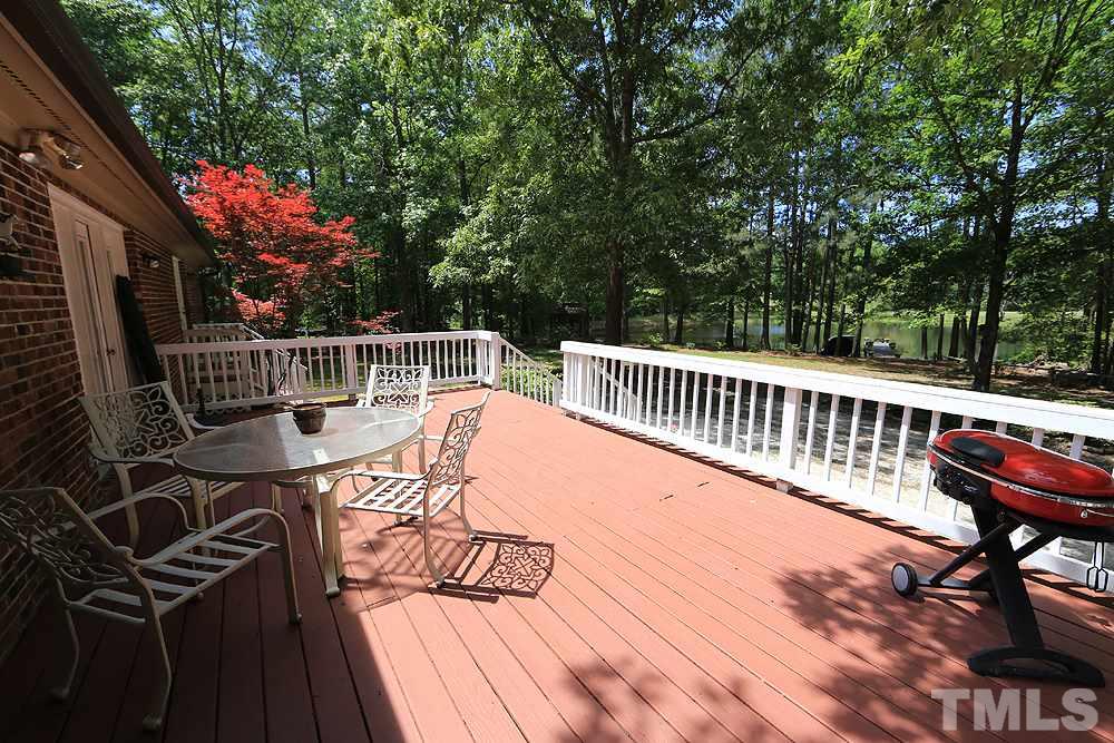 1295 Pilot-Riley Road Zebulon, NC 27597 - Photo 10 of 18 a view of balcony with wooden floor and seating space