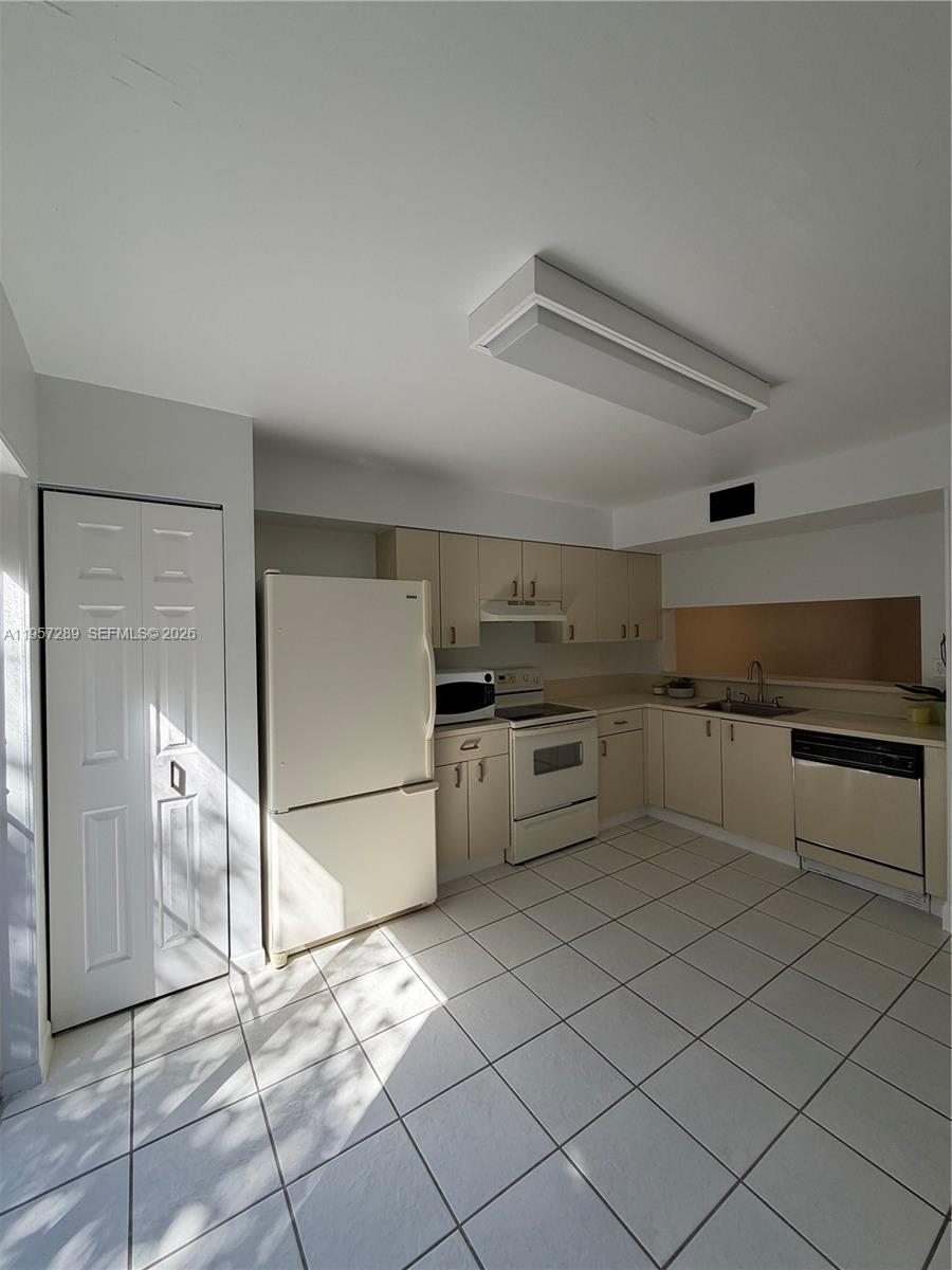 8260 Southwest 149th Court, Unit 9204 Miami, FL 33193 - Photo 8 of 25 a kitchen with stainless steel appliances granite countertop a refrigerator and a stove top oven