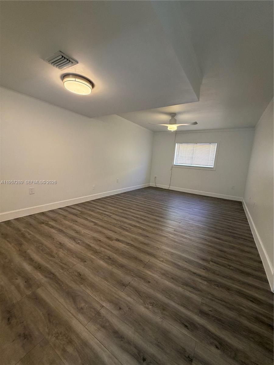 8260 Southwest 149th Court, Unit 9204 Miami, FL 33193 - Photo 9 of 25 an empty room with wooden floor and windows