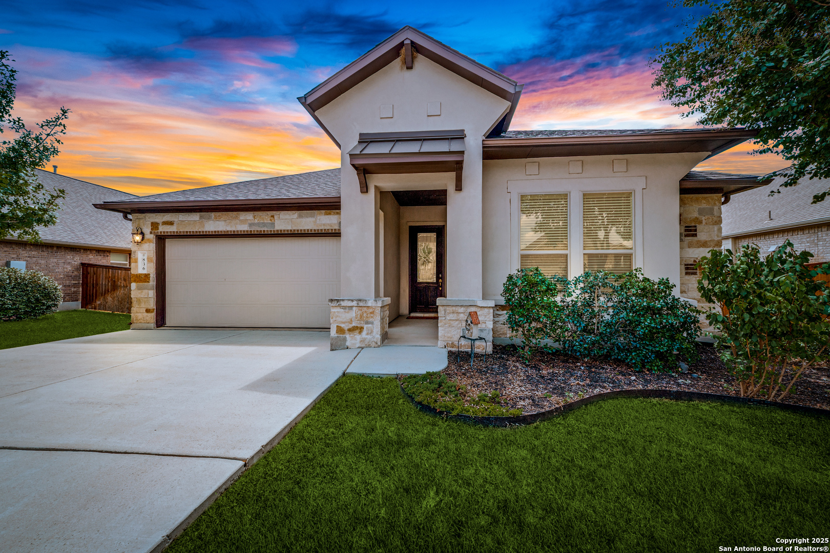 a front view of a house with a yard and garage