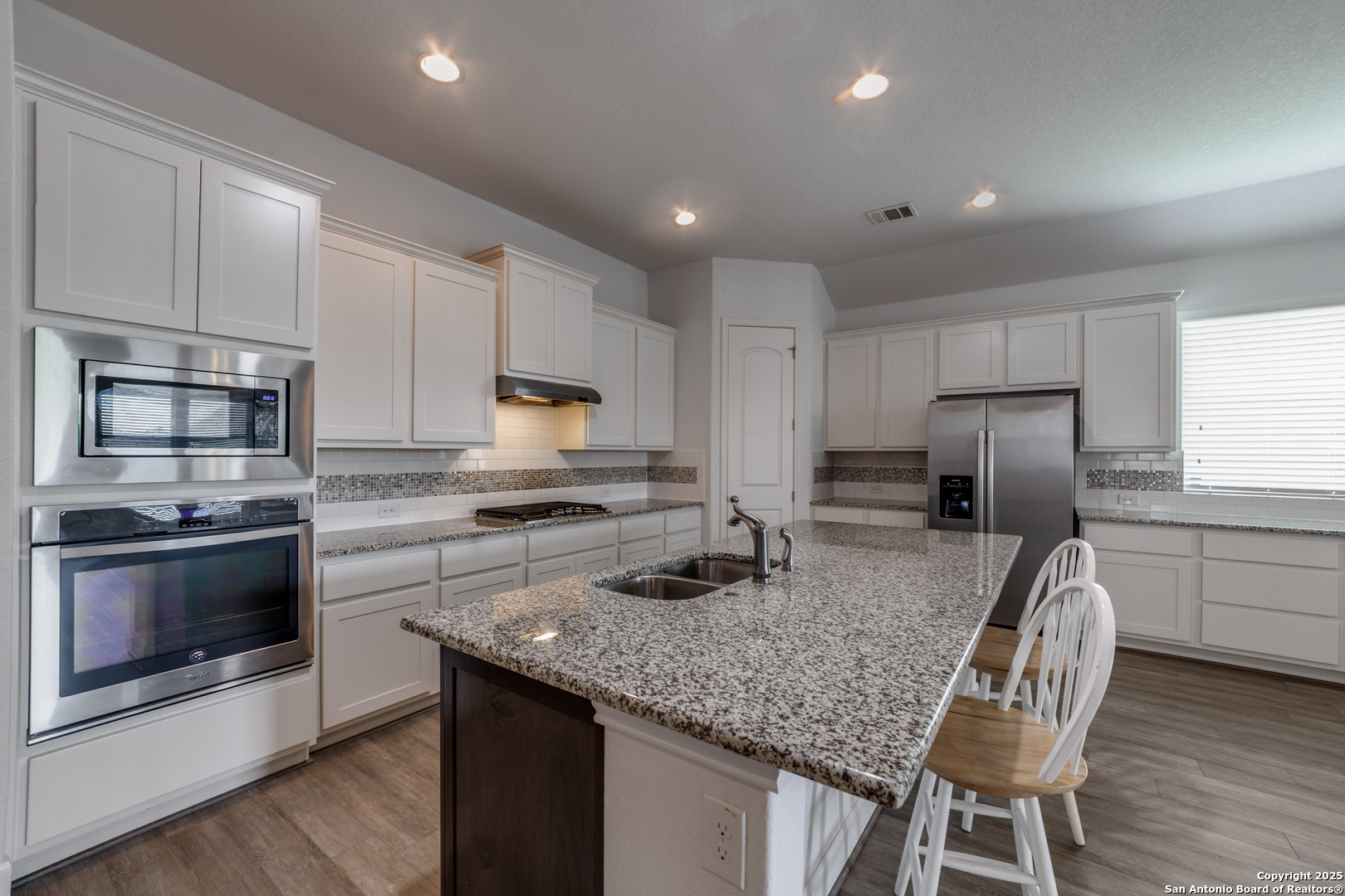 836 Silver Fox Cibolo, TX 78108 - Photo 7 of 26 a kitchen with kitchen island granite countertop a stove sink and microwave