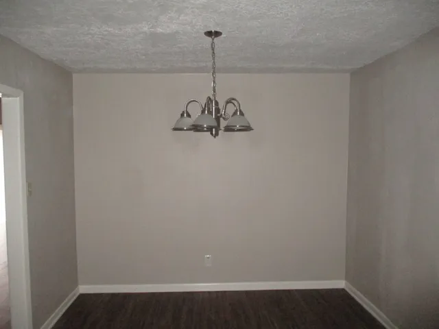 a view of a room with wooden floor and ceiling fan