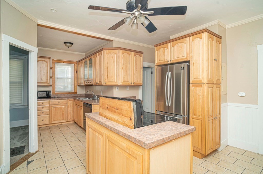 5 Exeter Street Taunton, MA 02780 - Photo 18 of 32 a kitchen with a refrigerator a sink and cabinets