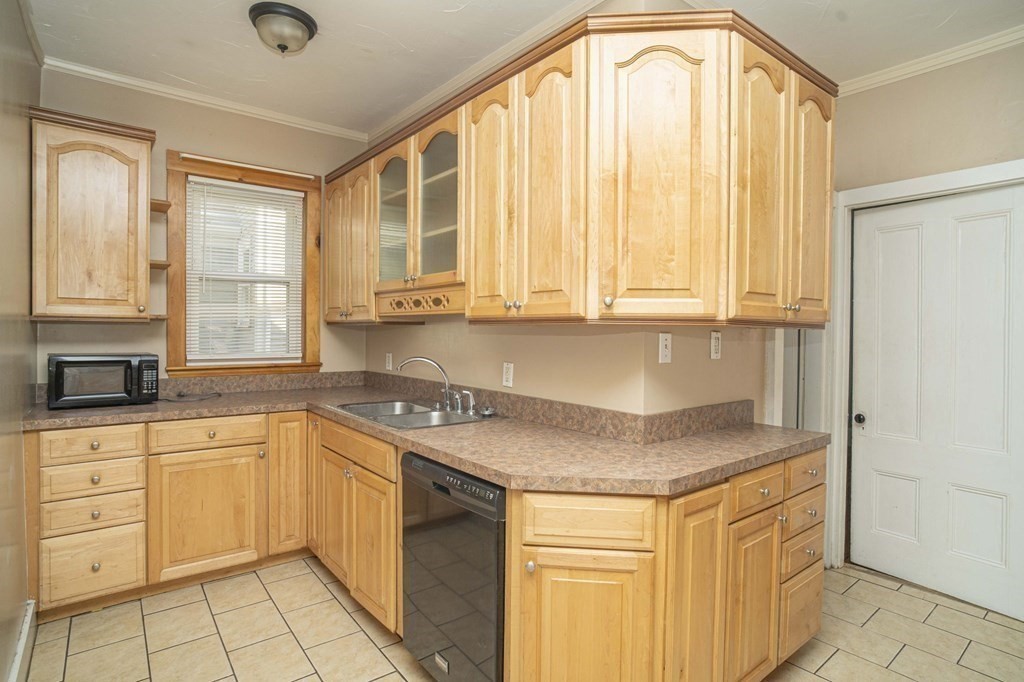 5 Exeter Street Taunton, MA 02780 - Photo 19 of 32 a kitchen with stainless steel appliances granite countertop a sink stove and cabinets