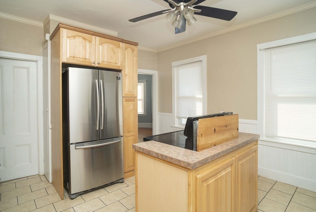 5 Exeter Street Taunton, MA 02780 - Photo 20 of 32 a kitchen with stainless steel appliances granite countertop a refrigerator a stove a sink and a window